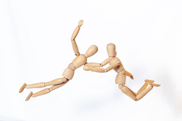 Wooden men in motion. The concept of people's relationships. Friends.Wooden doll Used to simulate human gestures.