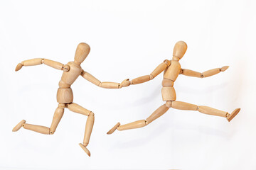 Wooden men in motion. The concept of people's relationships. Friends.Wooden doll Used to simulate human gestures.