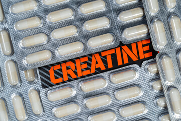 Creatine capsules or pills food supplement . Overhead close up detail.