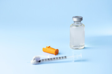 syringe for injectable medication on blue background