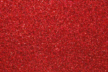 Red defocused glitter texture as background