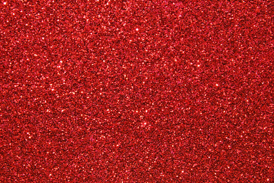 Red defocused glitter texture as background