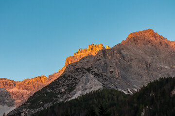Fototapeta premium Scenic sunrise view of majestic mountain peak of Dreischusterspitze in untamed Sexten Dolomites, South Tyrol, Italy, Europe. Hiking in panoramic Fischleintal (Val Fiscalina), Italian Alps. Wanderlust