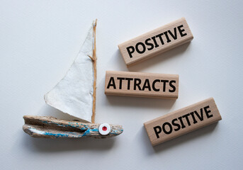 Positive attracts Positive symbol. Wooden blocks with words Positive attracts Positive. Beautiful...