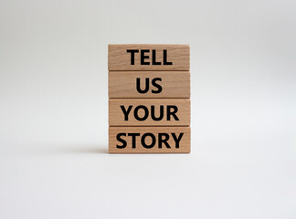 Tell us your story symbol. Concept words Tell us your story on wooden blocks. Beautiful white background. Business and Tell us your story concept. Copy space.