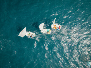 Aerial View of Small Sailboats Racing on Sea