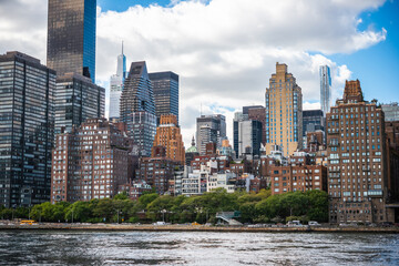 A view of the upper East Side in Manhattan with the East River in the foreground in New York City, United States.