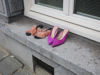 two pair of shoes left on the windowsill