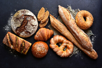 Homemade fresh baked bread with flour and ears. Top view with copy space.