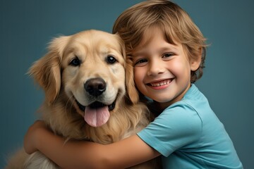 cute kid boy with adorable golden retriever dog smiling on turquoise blue background. Heartwarming portrait,