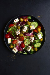 Fresh vegetable salad with feta cheese. Top view with copy space.