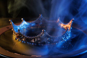 Fabulous golden crown of the king on a dark background. Panoramic view of the blue and red fog. Mockup for your logo.