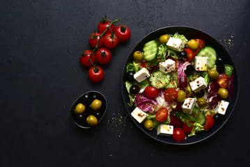 Poster Fresh vegetable salad with feta cheese. Top view with copy space. © lilechka75