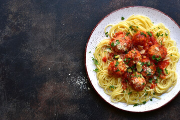 Spaghetti pasta with meatballs in tomato sauce. Traditional dish of italian cuisine. Top view with copy space.