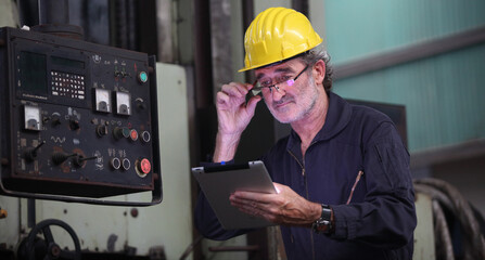 worker or engineer working in factory with safety uniform , safety hat and safety glasses , image is safety concept or happy workplace