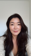 Naklejka premium 40 year old asian talking selfie