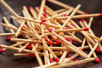 Matchsticks pile with red sulfur in household wooden bowl