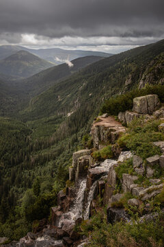 Vertical Landscape of Pancava Waterfall in Krkonose National Park during Cloudy Weather. Outdoor Nature with Forest, Trees and Mountain in Czech Republic.