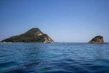 Fototapeta na wymiar Turtle Island with Ionian Sea in Zakynthos. Beautiful Marathonisi with Blue Water during Summer Day in Greece.