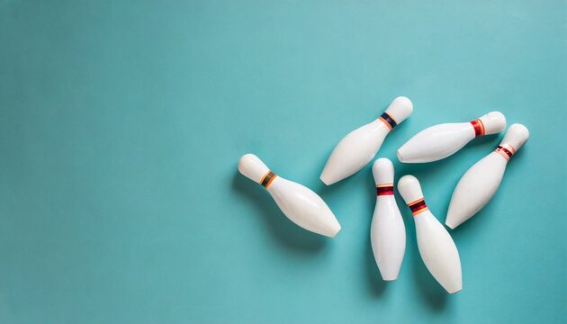 minimalist photo of bowling pins over turquoise blue background flat lay top down image of white bowling pins with copy space
