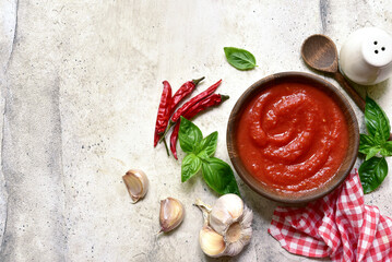 Homemade spicy tomato sauce with ingredients for making. Top view with copy space.
