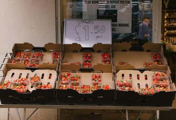 strawberries outside the front of a fruit store 