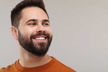Man with clean teeth smiling on gray background, space for text - obrazy, fototapety, plakaty