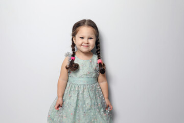 Cute little girl on light grey background