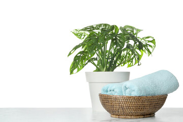 Fresh bath towels on table against white background