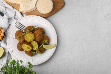 Delicious falafel balls served on light table, flat lay. Space for text