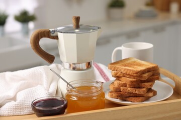 Breakfast time. Toasts, honey, jam and coffee in wooden tray, closeup