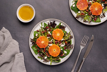 Food photography of salad with bloody orange, leaf mix, spinach, red lettuce, rocket, feta cheese, caramelized pecan, nut, sauce, vegetarian