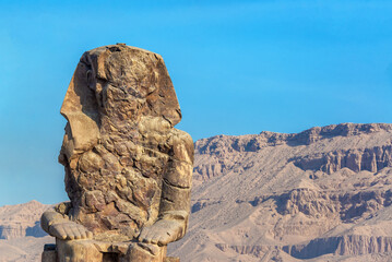 Closeup view of one of the Colossi of Memnon at the entrance to the Valley of the Kings near Luxor, Egypt