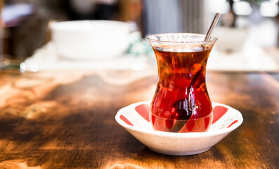 Turkish black tea in glass cup on wooden table