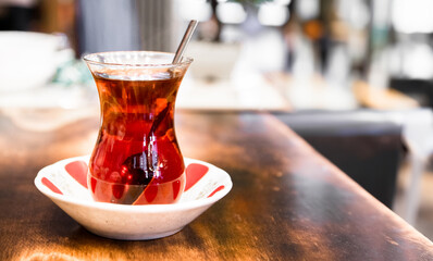Turkish black tea in glass cup on wooden table