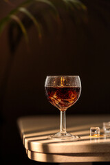 Cocktail on ice on a marble table of a michelin star restaurant. Luxury cocktail concept