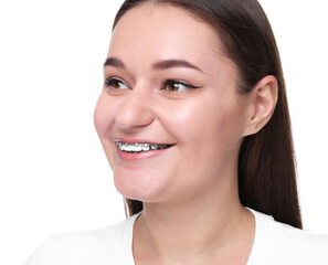 Smiling woman with dental braces on white background