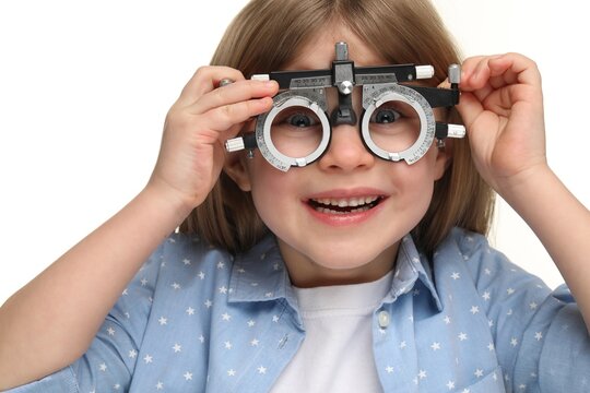 Vision testing. Little girl with trial frame on white background
