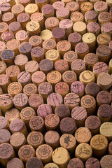 Background of used corks from red wine bottles vertically