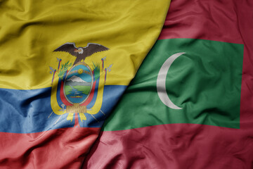 big waving national colorful flag of maldives and national flag of ecuador .