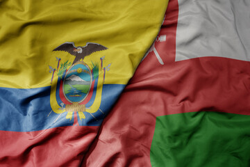 big waving national colorful flag of oman and national flag of ecuador .