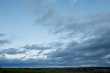 Panorama of dawn fire in the sky above the natural pasture. Golden red clouds just before sunrise. Picturesque landscape at sunrise. Beauty in nature