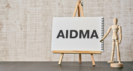 There is notebook with the word AIDMA. It is an abbreviation for AIDMA as eye-catching image. - obrazy, fototapety, plakaty
