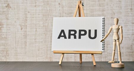 There is notebook with the word ARPU. It is an abbreviation for Average Revenue Per User as eye-catching image.