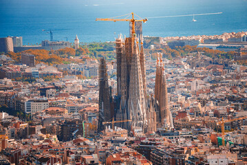 Panoramic view of Barcelona featuring the Sagrada Familia's spires against a cityscape backdrop,...