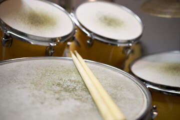 Drumsticks on a snare drum on a drumset