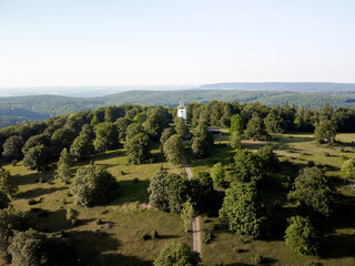A white tower in a green park with a view of the horizon. Germany countryside