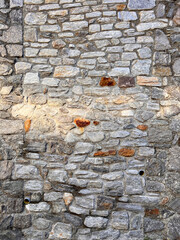 old quarry stone wall with gray and partly reddish stones