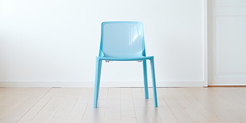 Blue plastic chair in white room with wood floor.