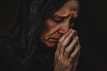 Fotobehang Woman in mourning praying and crying, mother and widow praying with a heartbreaking sob © Simn